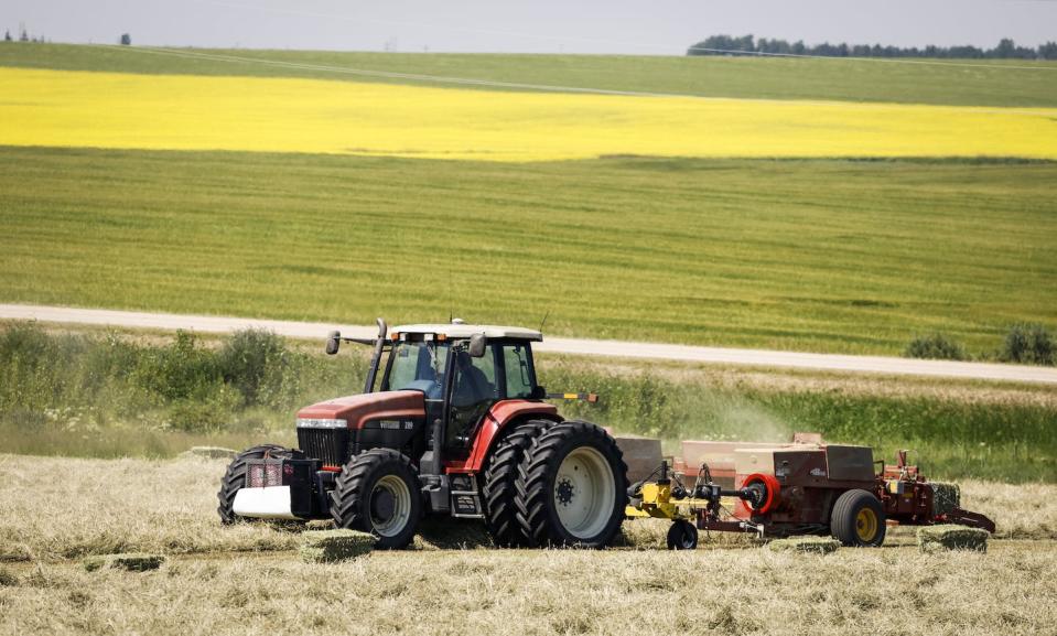 Farmers bale their hay crop near Cremona, Alta., in July 2022. THE CANADIAN PRESS/Jeff McIntosh