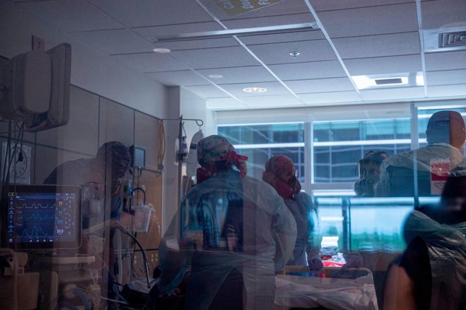 Nurses work together to “prone” a patient, or turn them onto their stomach at the ICU at Memorial Hospital in Gulfport on Wednesday, Aug. 11, 2021. It takes several nurses working together to prone a patient.