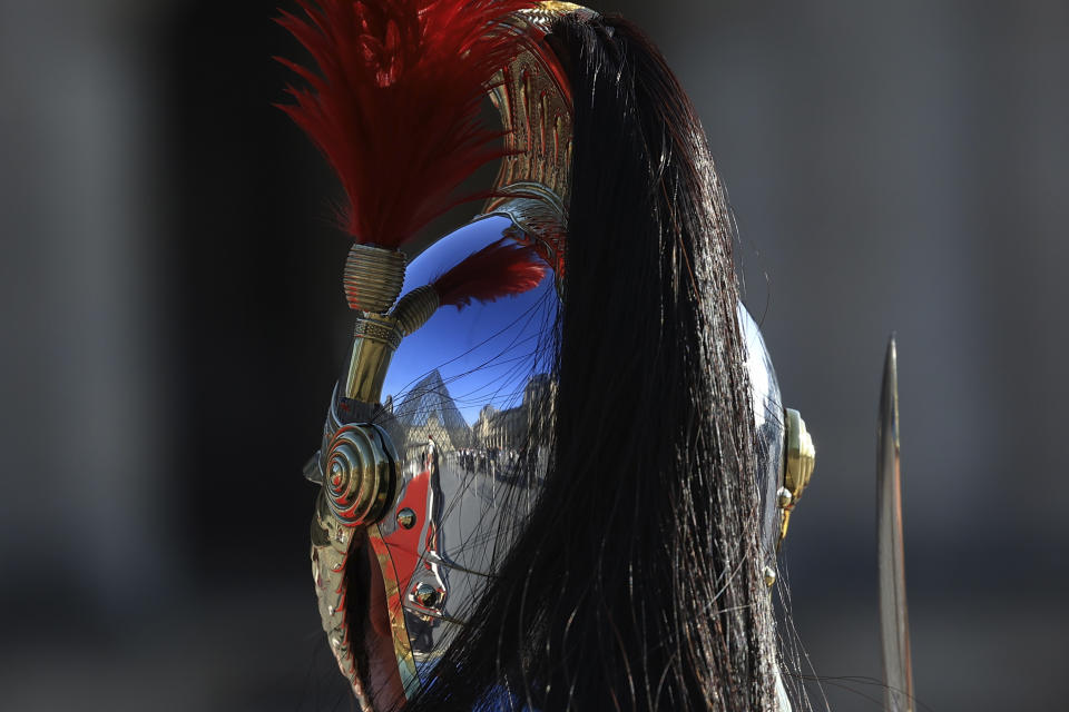 The pyramid of the Louvre museum is reflected in a Republican Guard's helmet before a dinner to honor Indian Prime Minister Narendra Modi, at the Louvre museum in Paris, Friday, July 14, 2023. France is looking to further strengthen cooperation on an array of topics ranging from climate to military sales and the strategic Indo-Pacific region. (AP Photo/Aurelien Morissard)