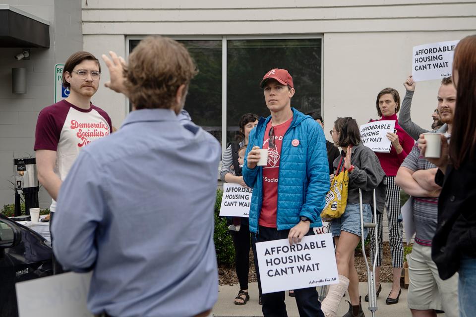 Asheville community members rallied for affordable housing before entering the Buncombe County Tourism Development Authority meeting May 31, 2023.