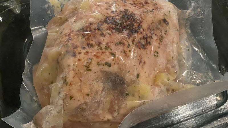 A vacuum-sealed pre-cooked turkey breast still in its package 