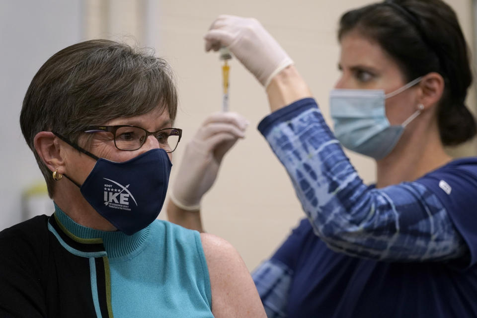 Public health nurse Lisa Horn prepares to give a COVID-19 vaccine injection to Kansas Democratic Gov. Laura Kelly Wednesday, Dec. 30, 2020, in Topeka, Kan. (AP Photo/Charlie Riedel)