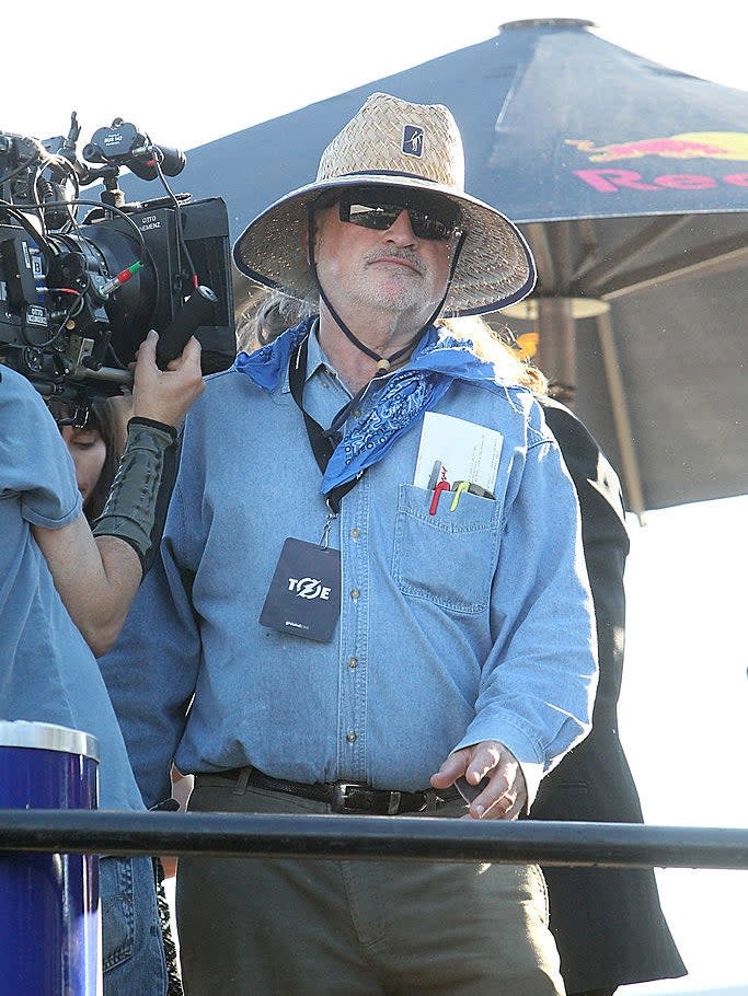 Terrance outside directing next to a camera