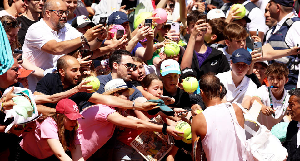 Seen here, Rafa Nadal signing autographs for fans after practice at the French Open. 