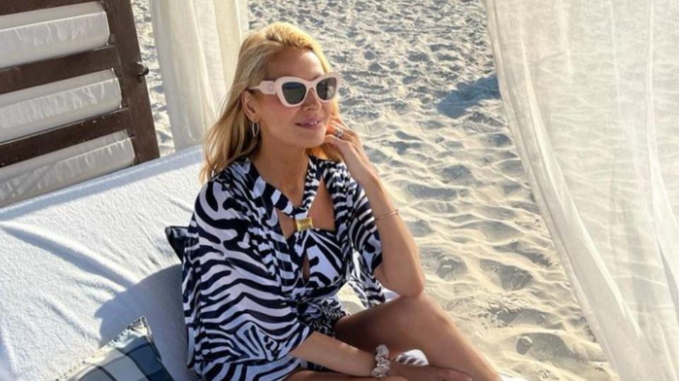 Tess Daly in a zebra-print outfit inside a beach cabana