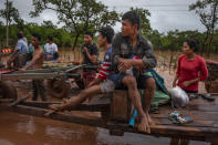 <p>Villagers evacuate to safer grounds after flash floods engulfed their villages the other night, on July 26, 2018 in Attepeu, southeastern Laos. (Photo: Jes Aznar/Getty Images) </p>