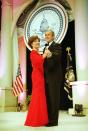 <p>In order to attend all of the inaugural balls thrown in George W. Bush's honor in January 2001, the couple could only dance for an estimated <a href="https://www.usnews.com/news/obama/articles/2008/12/17/the-long-and-sometimes-glamorous--history-of-inaugural-balls" rel="nofollow noopener" target="_blank" data-ylk="slk:29 to 50 seconds;elm:context_link;itc:0;sec:content-canvas" class="link ">29 to 50 seconds</a> at each event. Here, First Lady Laura Bush looks striking in a red lace long-sleeve gown by Texas designer Michael Faircloth. </p>