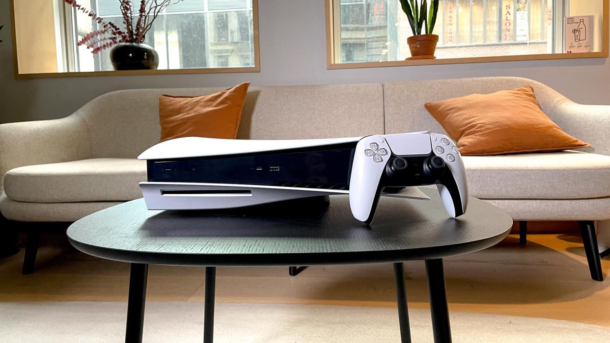  PS5 console and DualSense controller on a table 