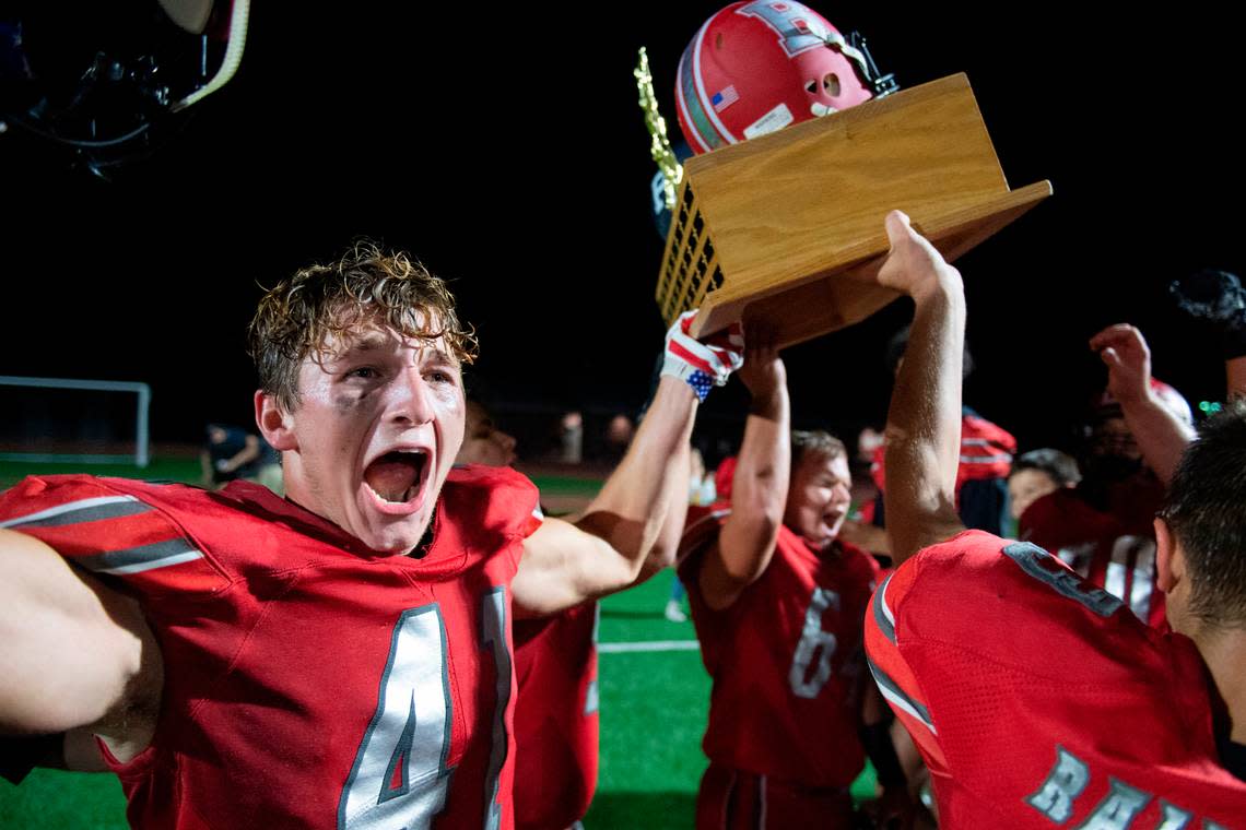 Bellefonte’s Nolan Weaver raises the Luther Trophy and after defeating Philipsburg-Osceola High School in a high school football game on Friday, Sept. 3, 2021 in Bellefonte, Pa.