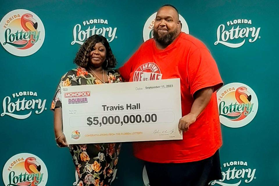 <p>Courtesy of Florida Lottery</p> Travis Hall (right) and his wife Nicole Hall