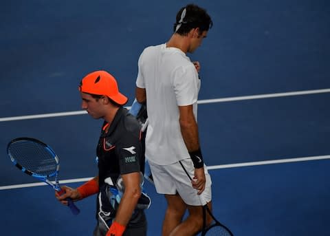 Switzerland's Roger Federer (R) walks on court during his men's singles second round match against Germany's Jan-Lennard Struff on day four of the Australian Open tennis tournament in Melbourne on January 18, 2018 - Credit: AFP