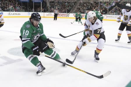 Dec 9, 2017; Dallas, TX, USA; Dallas Stars left wing Remi Elie (40) and Vegas Golden Knights center William Karlsson (71) fight for the puck during the third period at the American Airlines Center. The Golden Knights defeat the Stars 5-3. Mandatory Credit: Jerome Miron-USA TODAY Sports