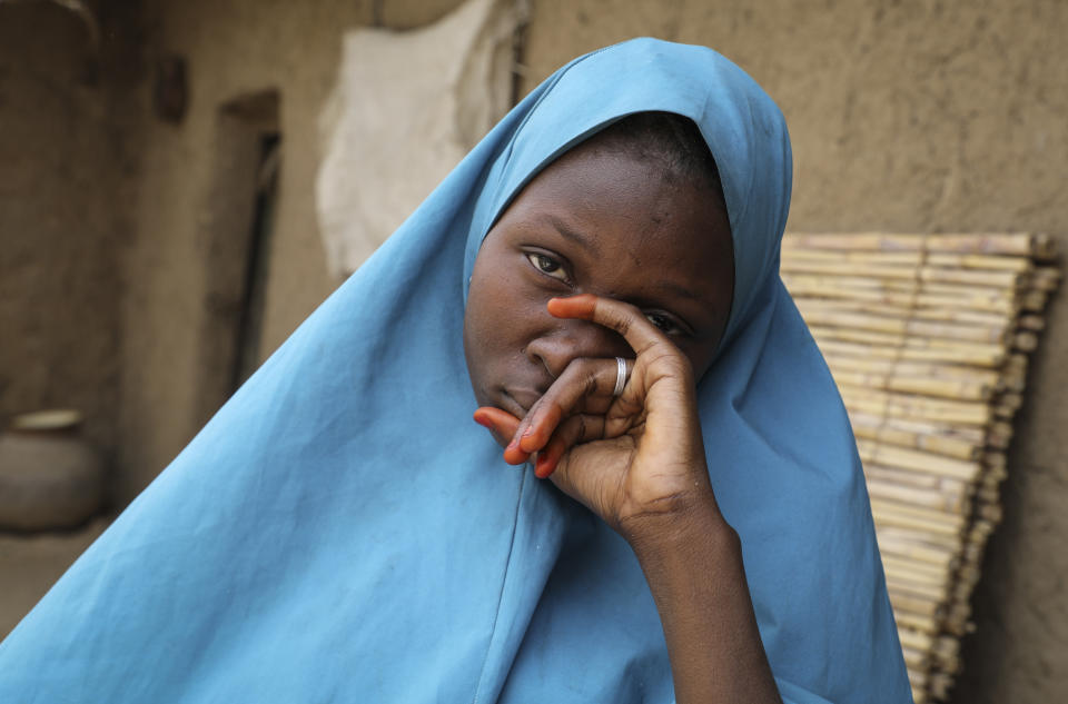 Student Masauda Umar, 20, who hid under her bed and managed to escape when gunmen abducted more than 300 girls from her boarding school on Friday, recounts her ordeal at her house in Jangebe town, Zamfara state, northern Nigeria Saturday, Feb. 27, 2021. Nigerian police and the military have begun joint operations to rescue the more than 300 girls who were kidnapped from the Government Girls Junior Secondary School, according to a police spokesman. (AP Photo/Ibrahim Mansur)