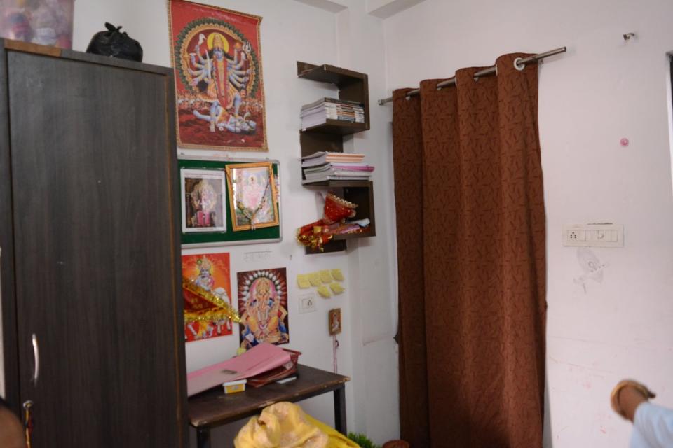 Pictures of Hindu gods and goddesses displayed above the study table of a student in Kota (Namita Singh/The Independent)