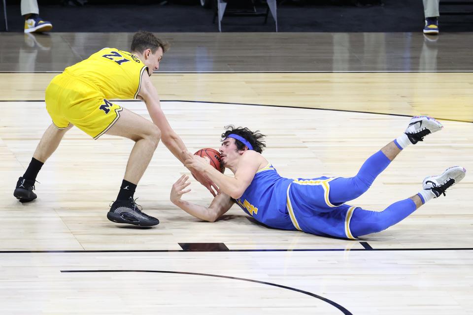 Jaime Jaquez Jr. dives for a loose ball against Franz Wagner in the Elite Eight.