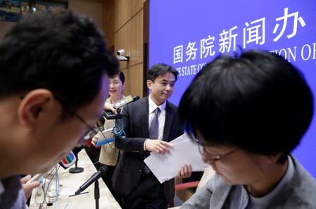 Yang Guang of the Hong Kong and Macau Affairs Office of the State Council leaves after a news conference in Beijing