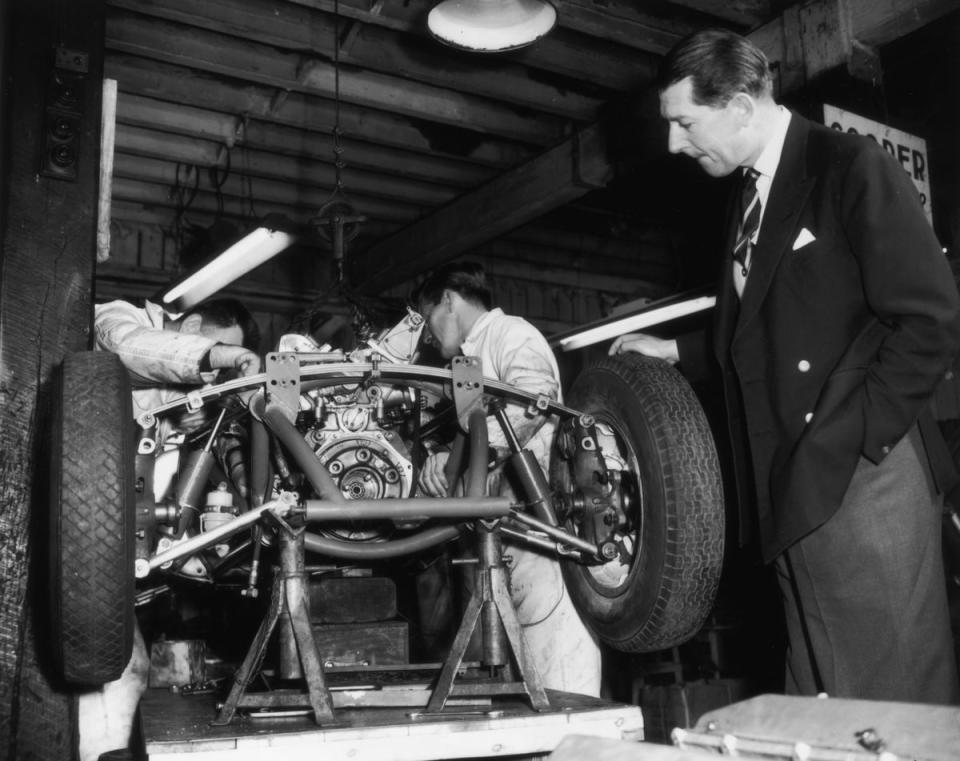 Rob Walker oversees the assembly of a new British Grand Prix racing car at his garage in Dorking in 1959 (Getty Images)