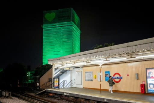 The crowd cheered wildly when a passing London Underground train sounded its horn, before the driver emerged from his cabin to unfurl a green flag