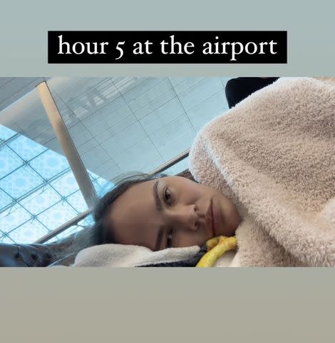 <p>Chrissy Teigen/Instagram</p> Chrissy Teigen at a Dubai airport during a five-hour flight delay