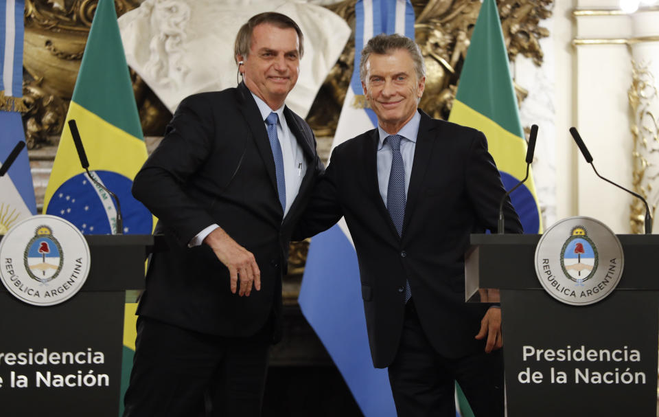 Brazil's President Jair Bolsonaro, left, embraces Argentina's President Mauricio Macri at the government house in Buenos Aires, Argentina, Thursday, June 6, 2019.(AP Photo/Natacha Pisarenko)