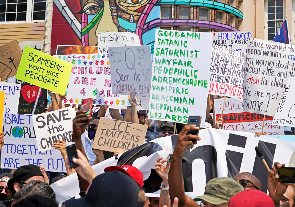 Signs with various conspiracy theories are on display at a “Save the Children” rally in Los Angeles on Aug. 22<span class="copyright">Jamie Lee Curtis Taete</span>