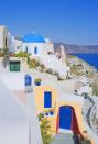 <p>A pop of Creamsicle orange is a pleasant surprise along the all-white streets of Santorini. </p>