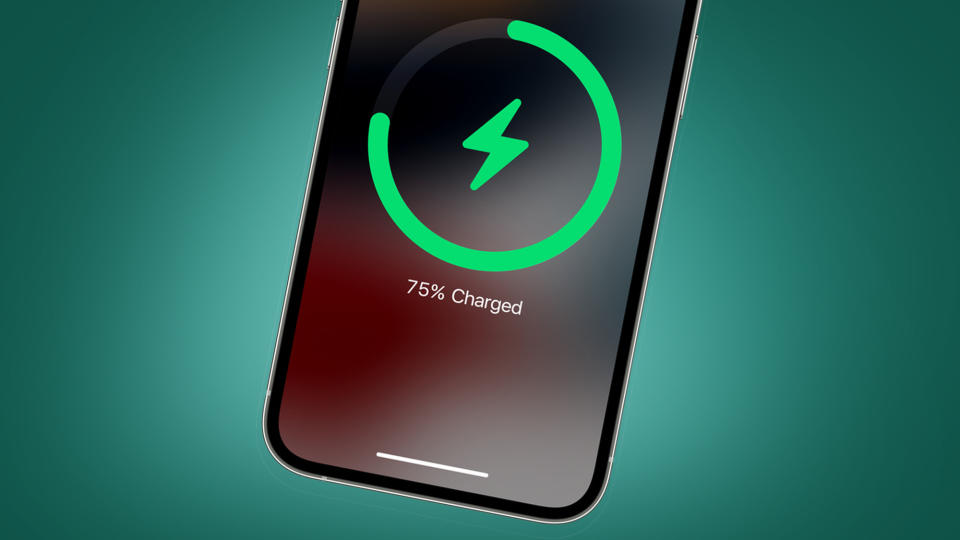  The Apple iPhone 14 charging on a green background. 