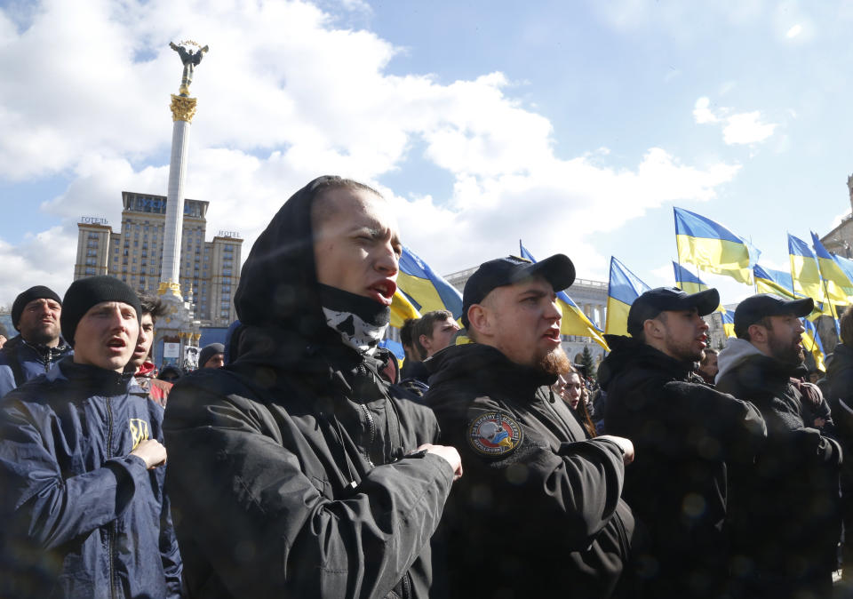 Far-right demonstrators gesture during a rally against corruption in downtown Kiev, Ukraine, Saturday, March 23, 2019. (AP Photo/Efrem Lukatsky)