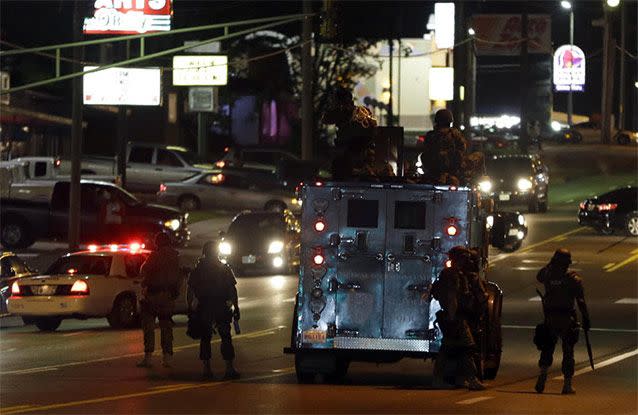 An explosive device deployed by police flies in the air as police and protesters clash. Source: AP Photo