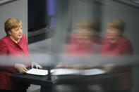 German Chancellor Angela Merkel delivers her speech during a parliament session about a new law to battle the coronavirus pandemic at the parliament Bundestag in Berlin, Germany, Friday, April 16, 2021. (AP Photo/Markus Schreiber)