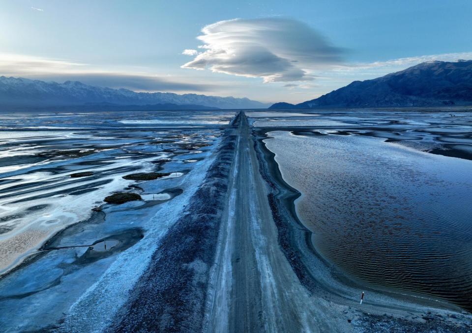 Water in Owens Lake in Lone Pine, surrounded by snowy mountains.