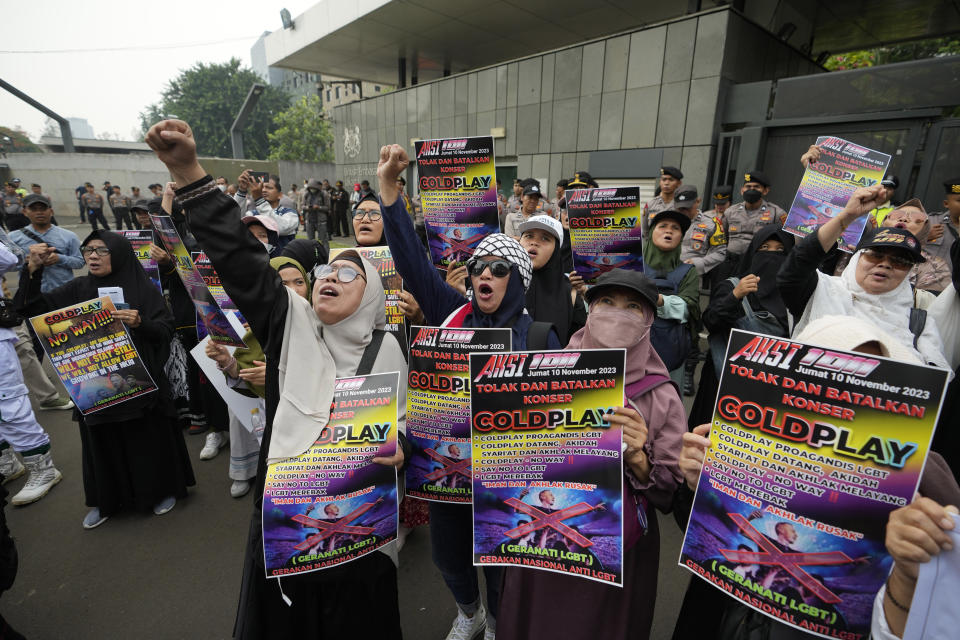Muslims shout slogans during a rally against British band Coldplay outside the British embassy in Jakarta, Indonesia, Friday, Nov. 10, 2023. Dozens of conservative Muslims marched in Indonesia's capital on Friday calling for cancellation of Coldplay's concert later this month, saying the British band's support of lesbian, gay, bisexual, and transgender will corrupt young people. (AP Photo/Achmad Ibrahim)