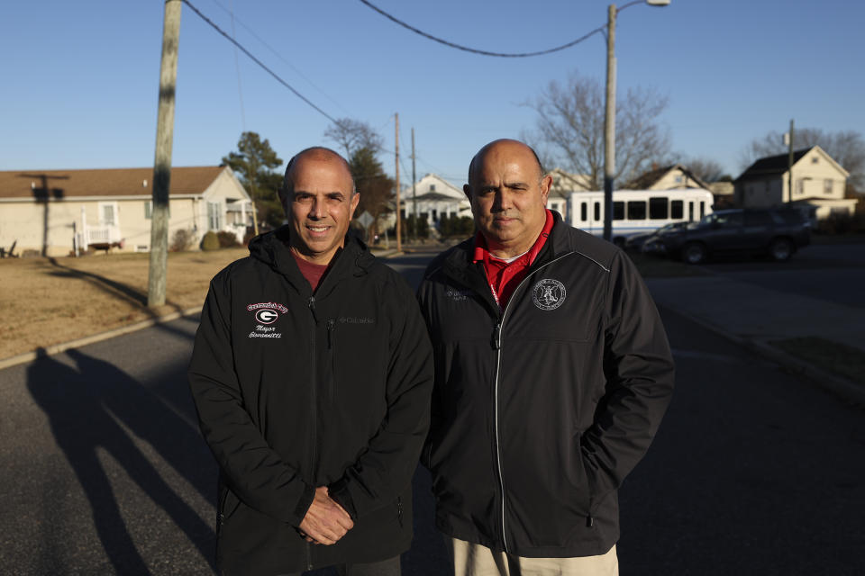 John Giovannitti, left, mayor-elect of Paulsboro, and brother Vince Giovannitti, mayor of Greenwich Township, stand together for a portrait outside of the Greenwich Township Municipal Building in Gibbstown, N.J., on Tuesday, Dec. 12, 2023. (Heather Khalifa/The Philadelphia Inquirer via AP)