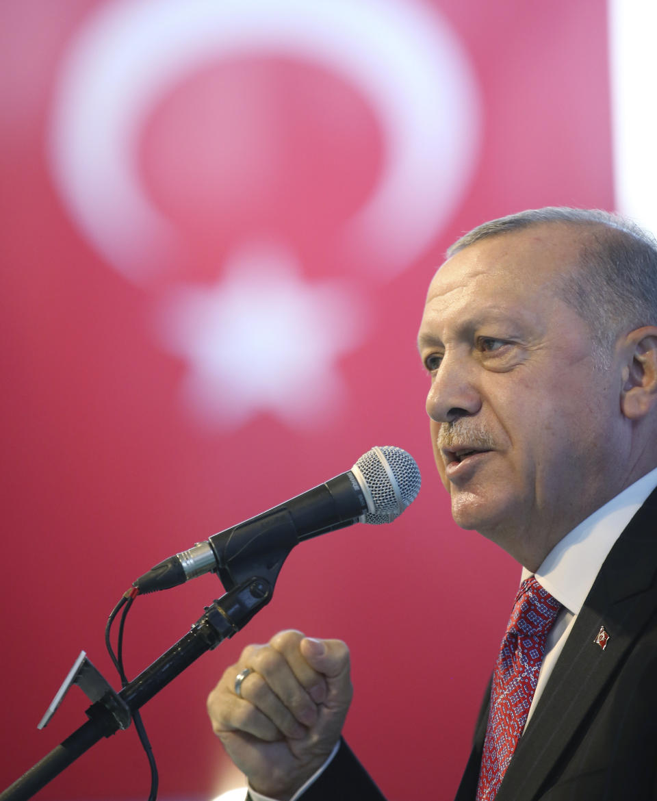 Turkey's President Recep Tayyip Erdogan addresses his party members, in Ankara, Turkey, late Thursday, Aug. 13, 2020. Erdogan warned of a "high price" to be paid for any attack on the Turkish search vessel Oruc Reis and even suggested that Turkey had already responded to an incident. (Turkish Presidency via AP, Pool)