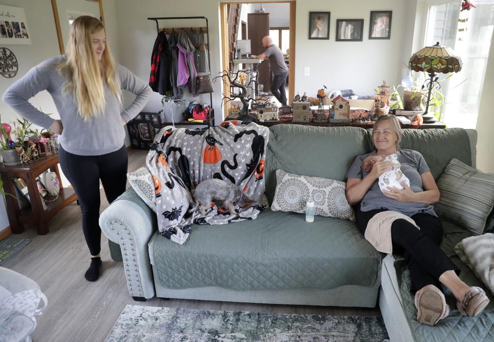 Joan Cooney, right, holds her grandson Archer Phillips while planning their day with his mother Amanda Phillips on Wednesday, October 18, 2023, in Omro, Wis. 
Wm. Glasheen USA TODAY NETWORK-Wisconsin