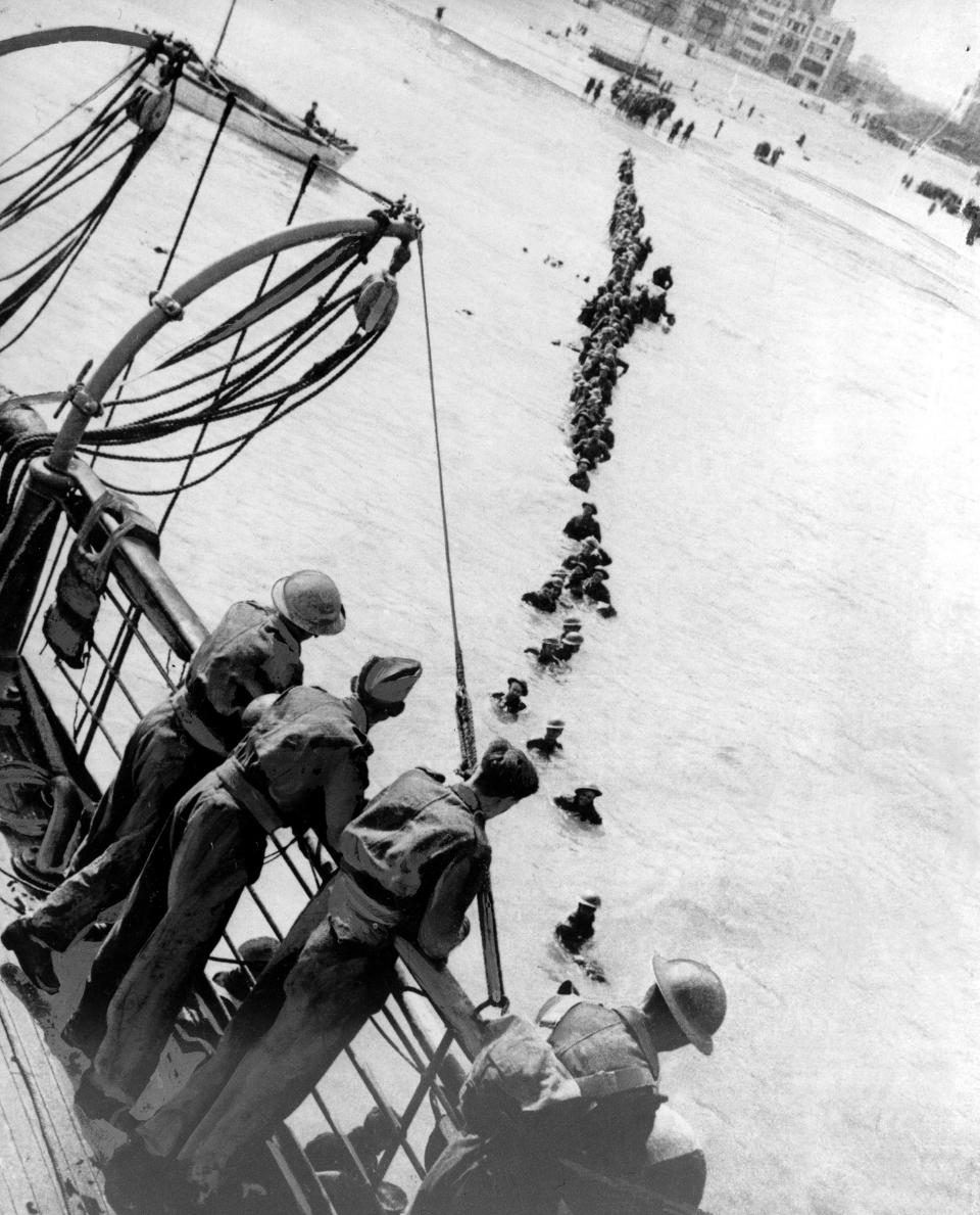 Soldiers of the British Expeditionary Force wade through shallow water to a rescue vessel that will take them back to England from Nazi-occupied Dunkirk, France, on June 13, 1940.