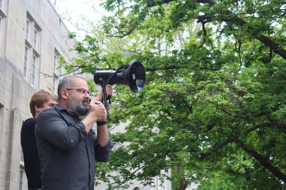 IU Professor Abdulkader Sinno leads chants for Indiana University President Pamela Whitten and Provost Rahul Shrivastav to resign during the protest outside of Bryan Hall on Monday, April 29.