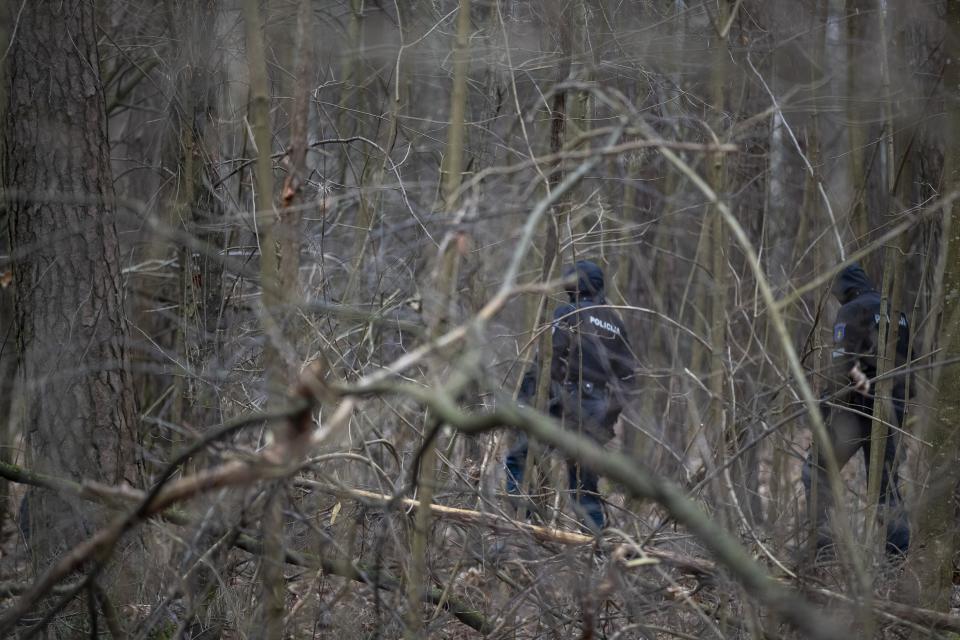 Police officers inspect the territory near the house of Leonid Volkov, a close associate of the late Russian opposition leader Alexei Navalny, in Vilnius, Lithuania, Wednesday, March 13, 2024. Volkov on Wednesday blamed the government of Russian President Vladimir Putin after he was attacked with a hammer and tear gas outside his home near the Lithuanian capital, where he lives in exile, the late Navalny's anti-corruption foundation said.(AP Photo/Mindaugas Kulbis)