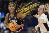 UConn's Aaliyah Edwards gets past Stanford's Lexie Hull during the second half of a college basketball game in the semifinal round of the Women's Final Four NCAA tournament Friday, April 1, 2022, in Minneapolis. UConn won 63-58 to advance to the finals. (AP Photo/Eric Gay)