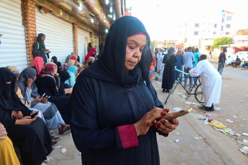 Residents and displaced people try to access the internet via Starlink in the city of Omdurman