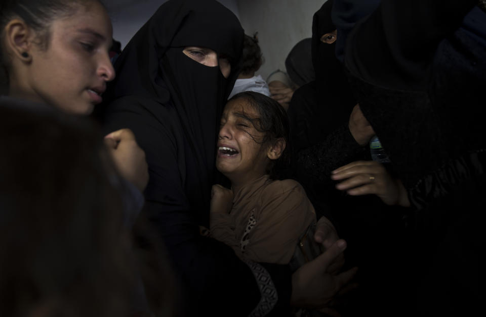 CORRECTS AGE FROM 12 TO 11 -Palestinian relatives of 11 year-old boy, Majdi al-Satari, who was shot and killed by Israeli troops on Friday's ongoing protest at the Gaza Strip's border with Israel, mourn at the family home during his funeral in town of Rafah, Southern Gaza Strip, Saturday, July 28, 2018. Gaza health officials said two Palestinians were killed and dozens injured by Israeli fire at a weekly border protest on Friday. (AP Photo/Khalil Hamra)