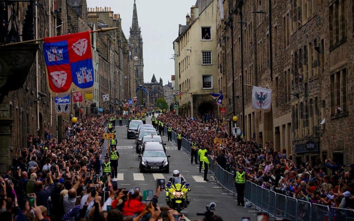 The hearse carrying the coffin of the late Queen passes along the Royal Mile, Edinburgh, as it makes its way to the Palace of Holyroodhouse from Balmoral - Peter Byrne/PA