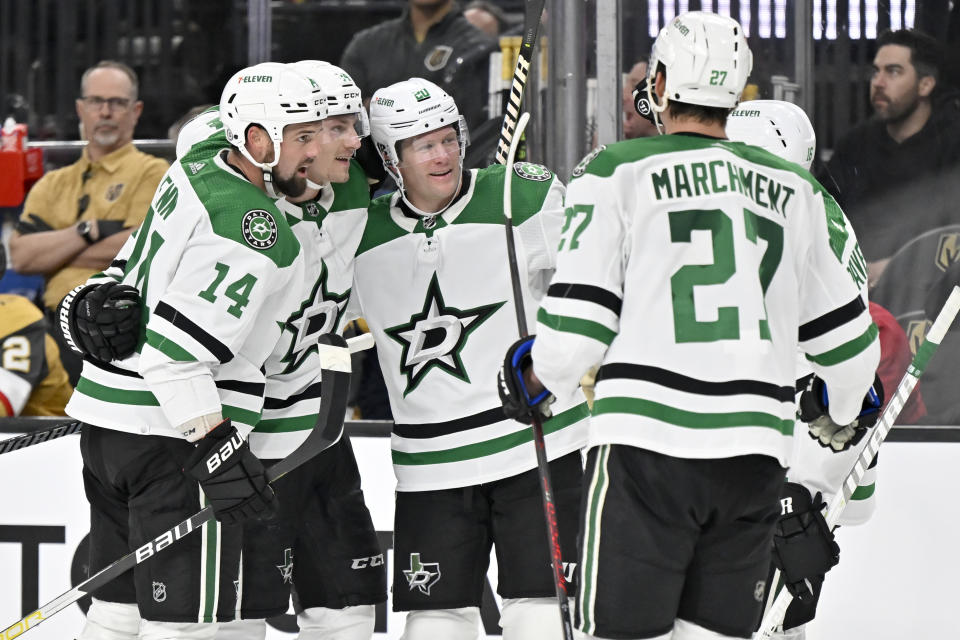 The Dallas Stars celebrate a goal by center Roope Hintz, center, against the Vegas Golden Knights during the third period of an NHL hockey game Saturday, Feb. 25, 2023, in Las Vegas. (AP Photo/David Becker)