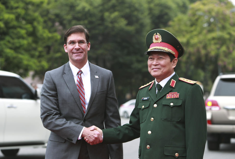 U.S. Defense Secretary Mark Esper, left, and Vietnamese Defense Minister Ngo Xuan Lich shake hands in Hanoi, Vietnam Wednesday, Nov. 20, 2019. Esper is on a visit to Vietnam to strengthen the military relations with the Southeast Asian nation. (AP Photo/Hau Dinh)