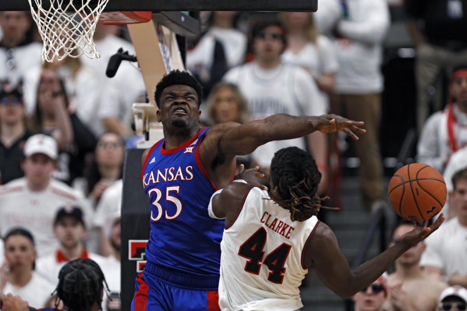 Kansas' Udoka Azubuike (35) blocks a shot by Texas Tech's Chris Clarke (44) during the first half of an NCAA college basketball game Saturday, March 7, 2020, in Lubbock, Texas. (AP Photo/Brad Tollefson)