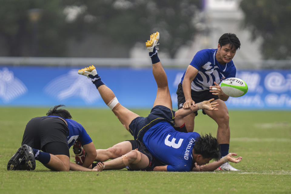 Thailand's Siwapreechakul Chawakorn tackles during men's placing Rugby Sevens match between Thailand and Afghanistan at the 19th Asian Games in Hangzhou, China, Tuesday, Sept. 26, 2023. (AP Photo/Louise Delmotte)