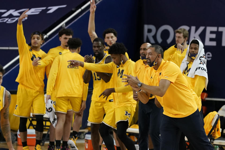 The Michigan bench reacts after a play during the first half of an NCAA college basketball game against Michigan State, Thursday, March 4, 2021, in Ann Arbor, Mich. (AP Photo/Carlos Osorio)