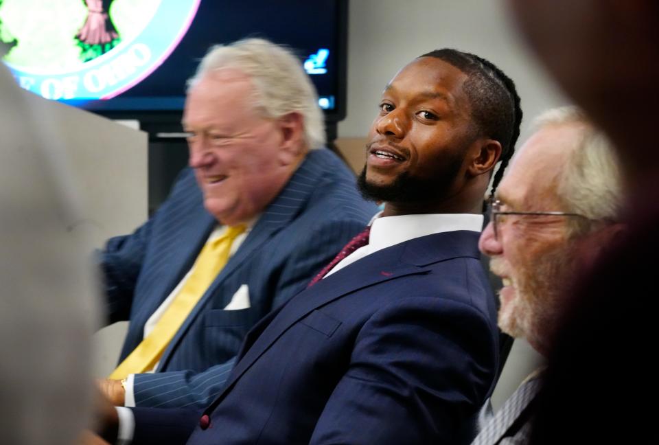 Cincinnati Bengals running back Joe Mixon shares a light moment with this attorney's, Scott Croswell, left, and Merlyn Shiverdekcer on day three of his aggravated menacing trial, Wednesday, August 16, 2023. The bench trial in Municipal Judge Gwen Bender’s courtroom involves an alleged road-rage incident on Jan. 21, 2023 involving a gun.