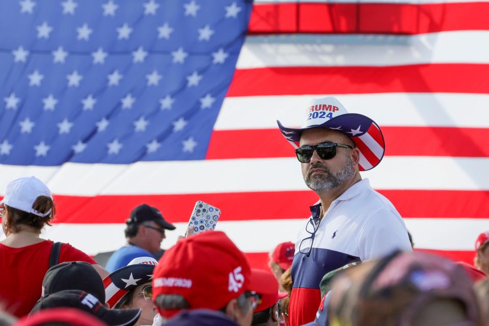 A Trump supporter looks on before former President Donald Trump is scheduled to speak at Ted Hendricks Stadium at Henry Milander Park in Hialeah, Florida, Wednesday, November 8, 2023.