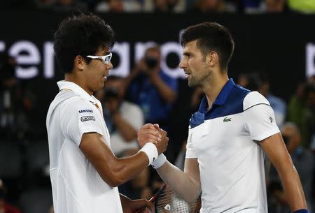Tennis - Australian Open - Rod Laver Arena, Melbourne, Australia, January 22, 2018. South Korea's Chung Hyeon shakes hands with Serbia's Novak Djokovic after Chung Hyeon wins the match. REUTERS/Edgar Su